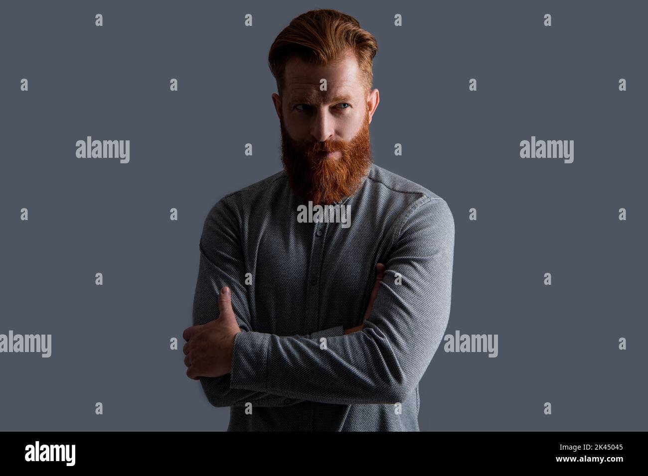 Confident bearded man keeping arms crossed. Irish man with red beard and moustache Stock Photo