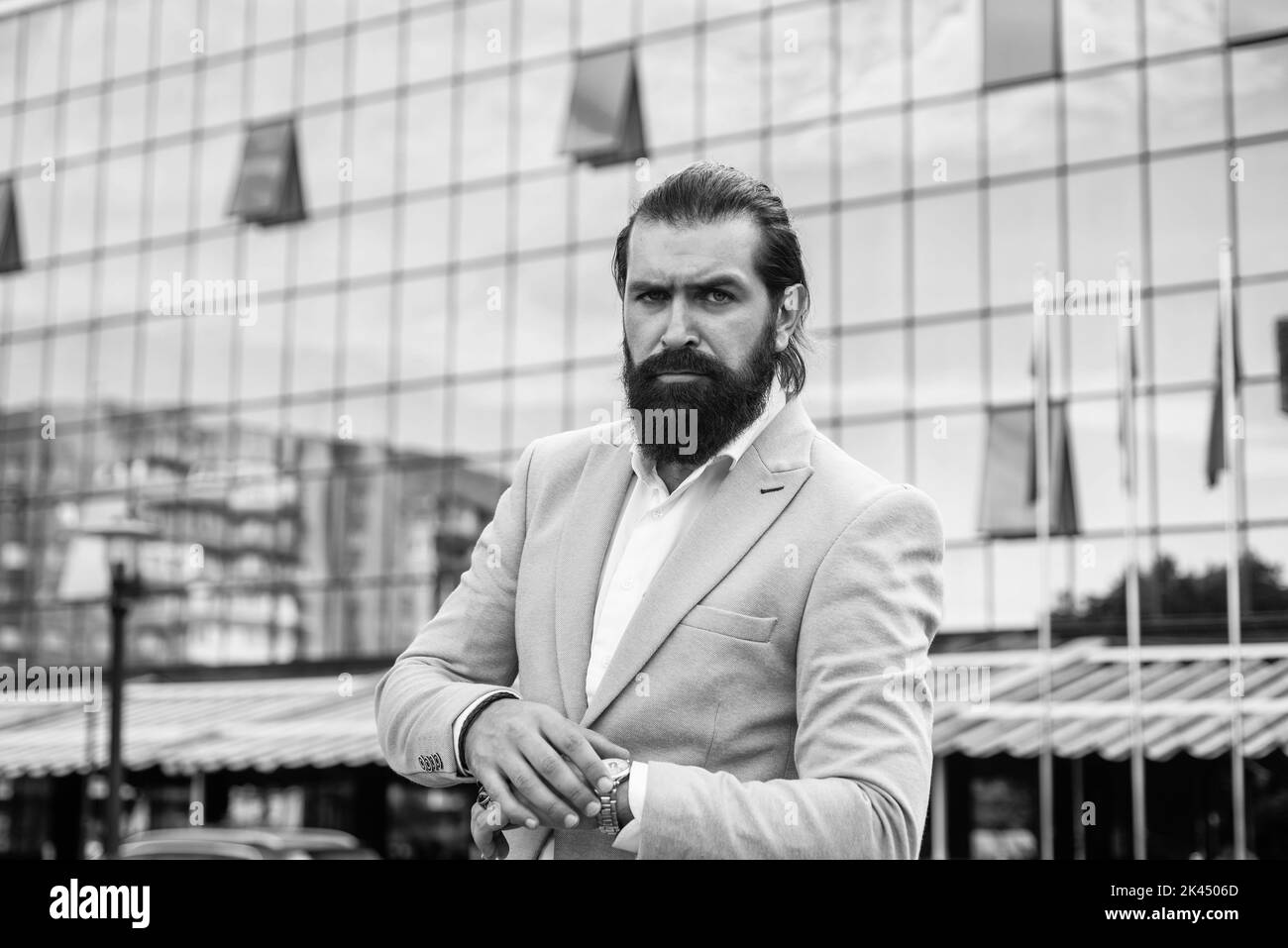 handsome mature bearded man in formal suit outdoor, business Stock Photo