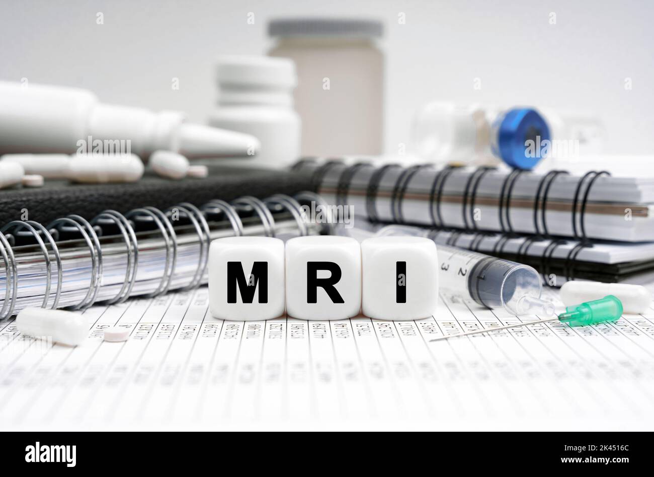 Medicine concept. On the table are diaries, medicines and cubes with the inscription - MRI Stock Photo