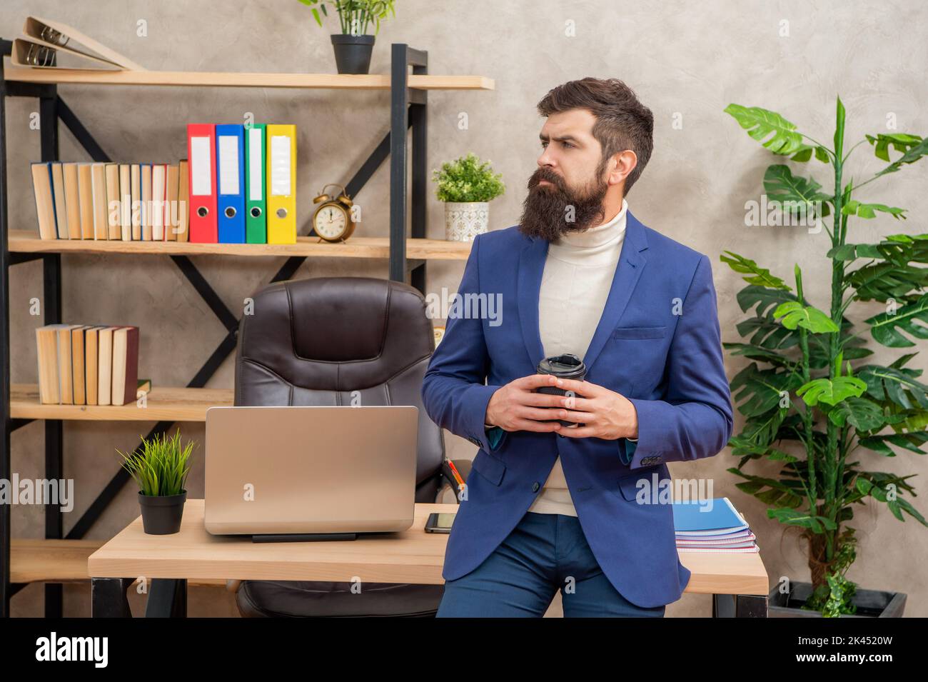 Thoughtful businessman taking coffee break during office work, thinking Stock Photo