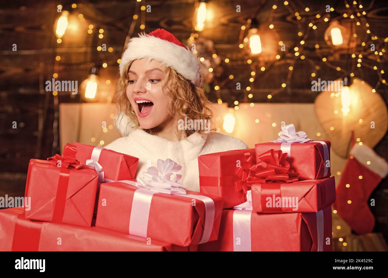 Holiday hustle and bustle. Christmas shopping concept. Preparing surprise. Pick perfect gift. Peace and joy sold here. Gift shop. Woman hold gift Stock Photo