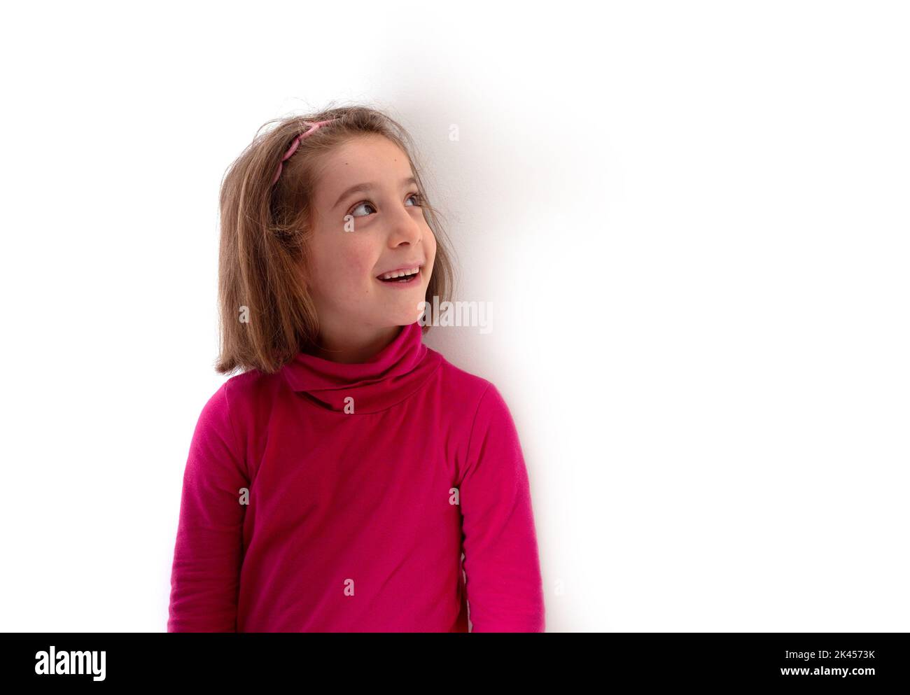 Little child girl wearing red polo neck or rollneck smiling and