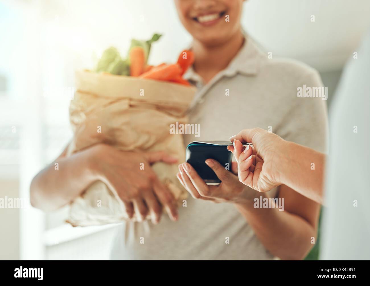 Credit card, courier home delivery and payment for vegetables, paper bag logistics and groceries. Customer hands giving point of sale shopping on rfid Stock Photo