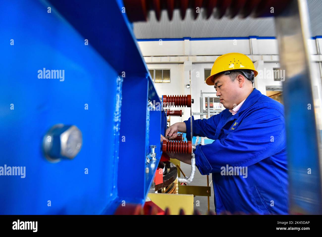 QINGZHOU, CHINA - SEPTEMBER 30, 2022 - A worker assembles a transformer ...