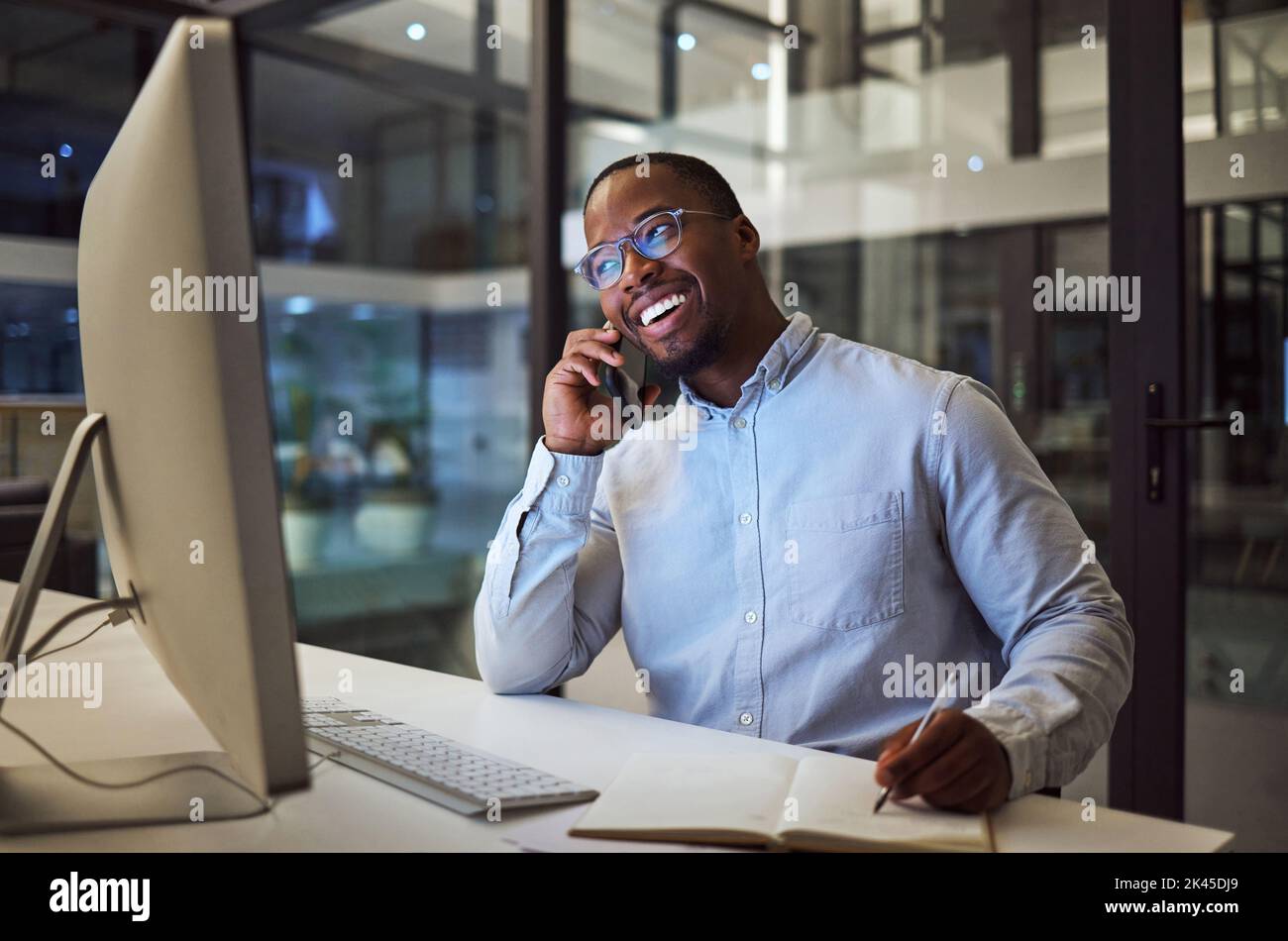 Phone call, notebook and computer black businessman at office planning, and writing success strategy for accounting company. South African corporate Stock Photo