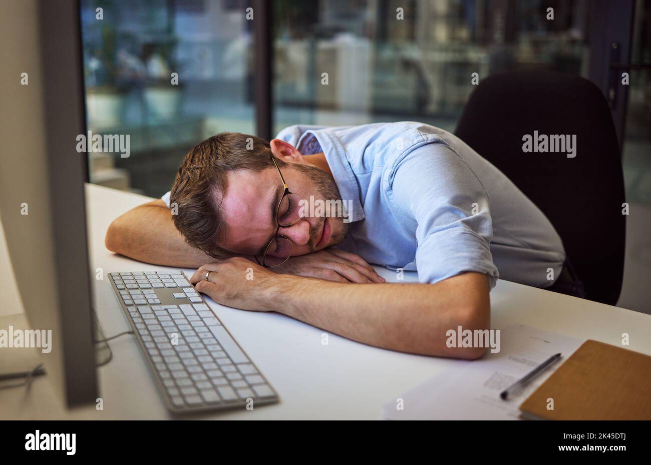 Burnout, tired and sleep with a business man sleeping on his desk while