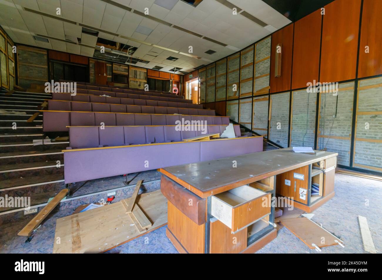 Derelict abandoned lecture theatre in an old college university training school department. Stock Photo