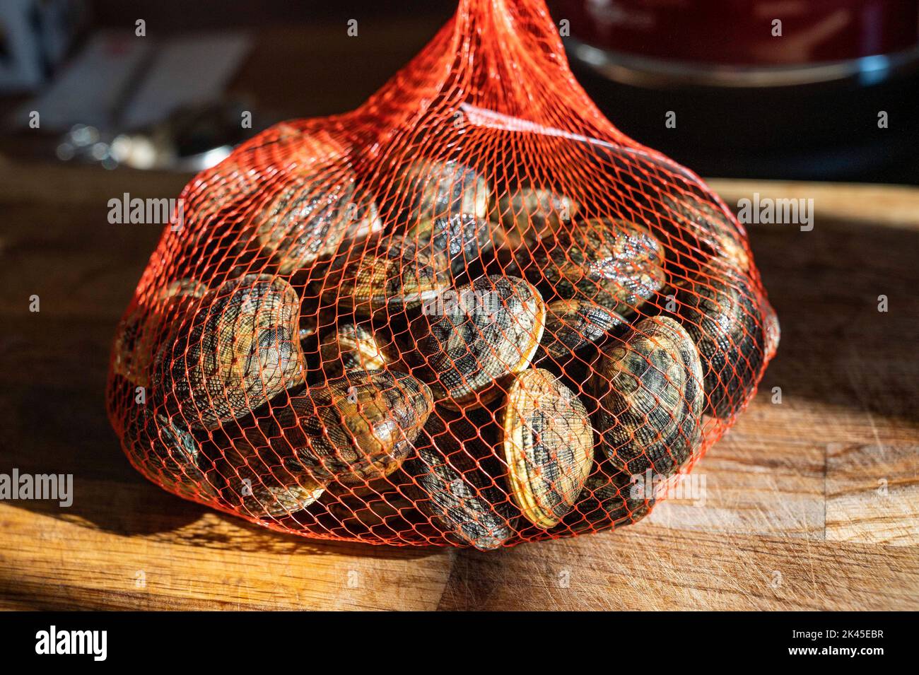 Bag of of fresh live clams ready for cooking  Photograph taken by Simon Dack Stock Photo