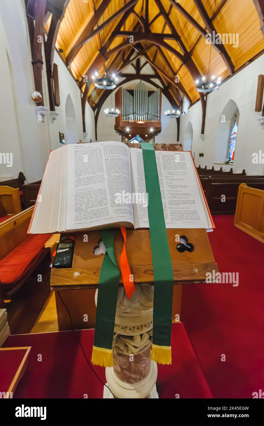 A bible sits on a pulpit open at Romans 13, 14 and 15. Stock Photo