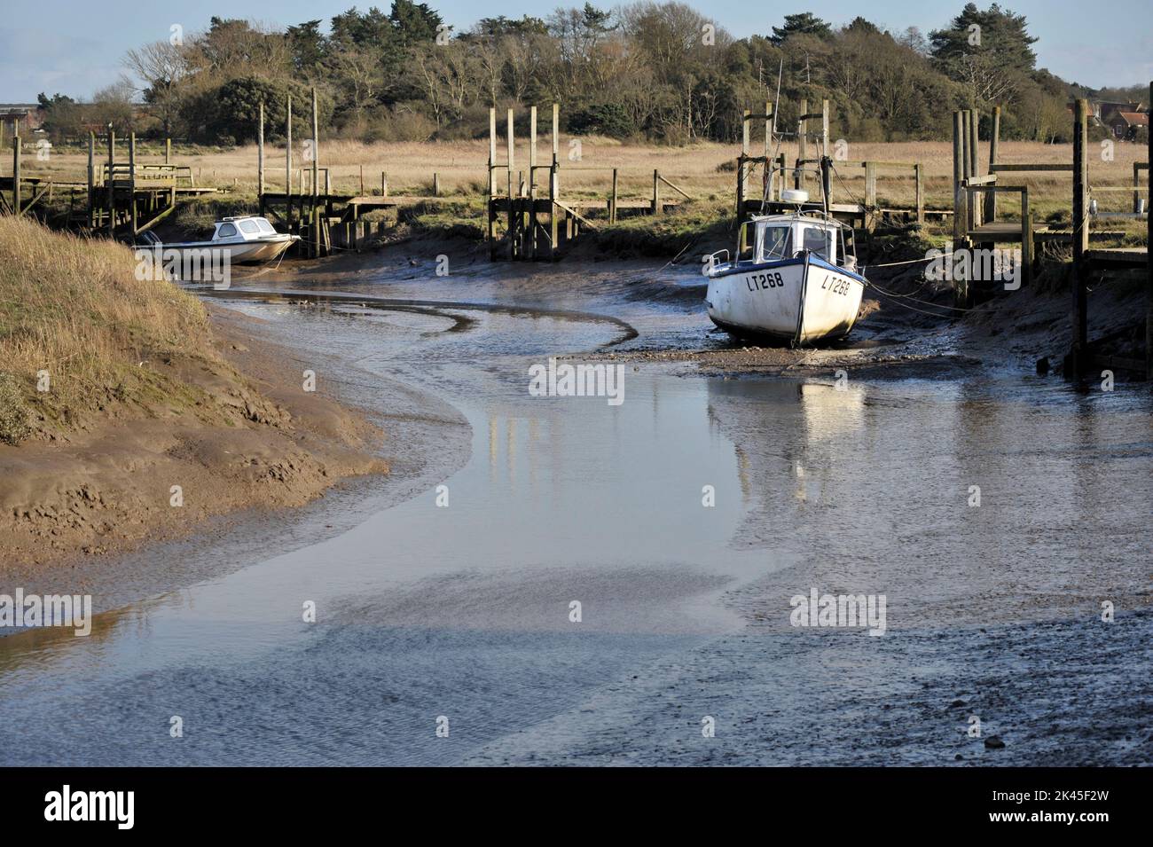 boats on the mud at low tide thornham north norfolk england Stock Photo