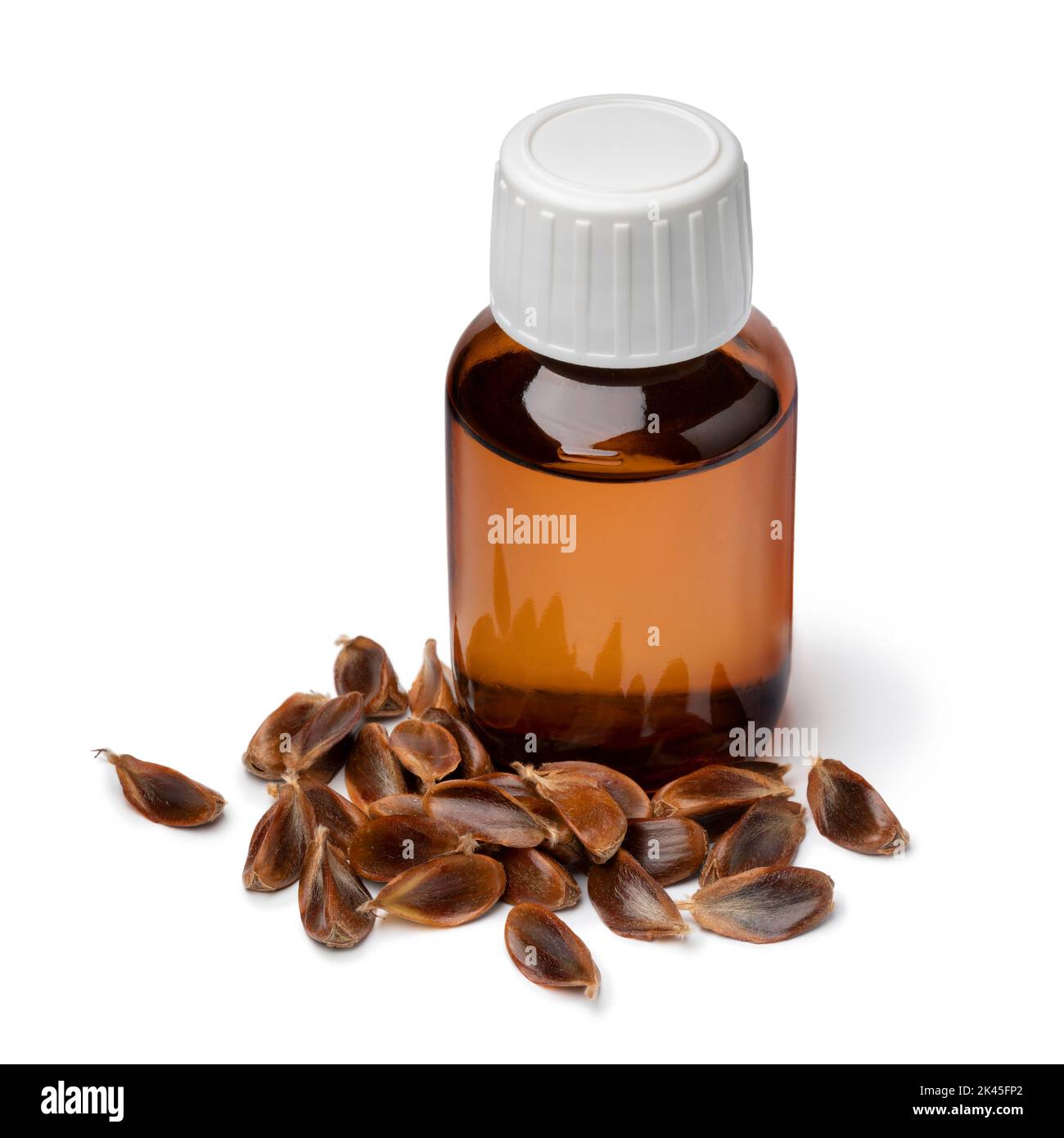 Bottle beechnut oil and a heap of beechnuts in front isolated on white background Stock Photo