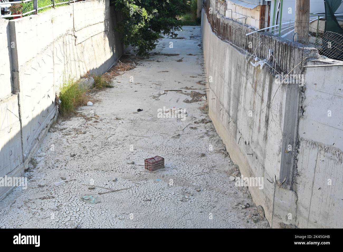 Regulated river basin. It is empty, dried up due to lack of water and precipitation. Stock Photo