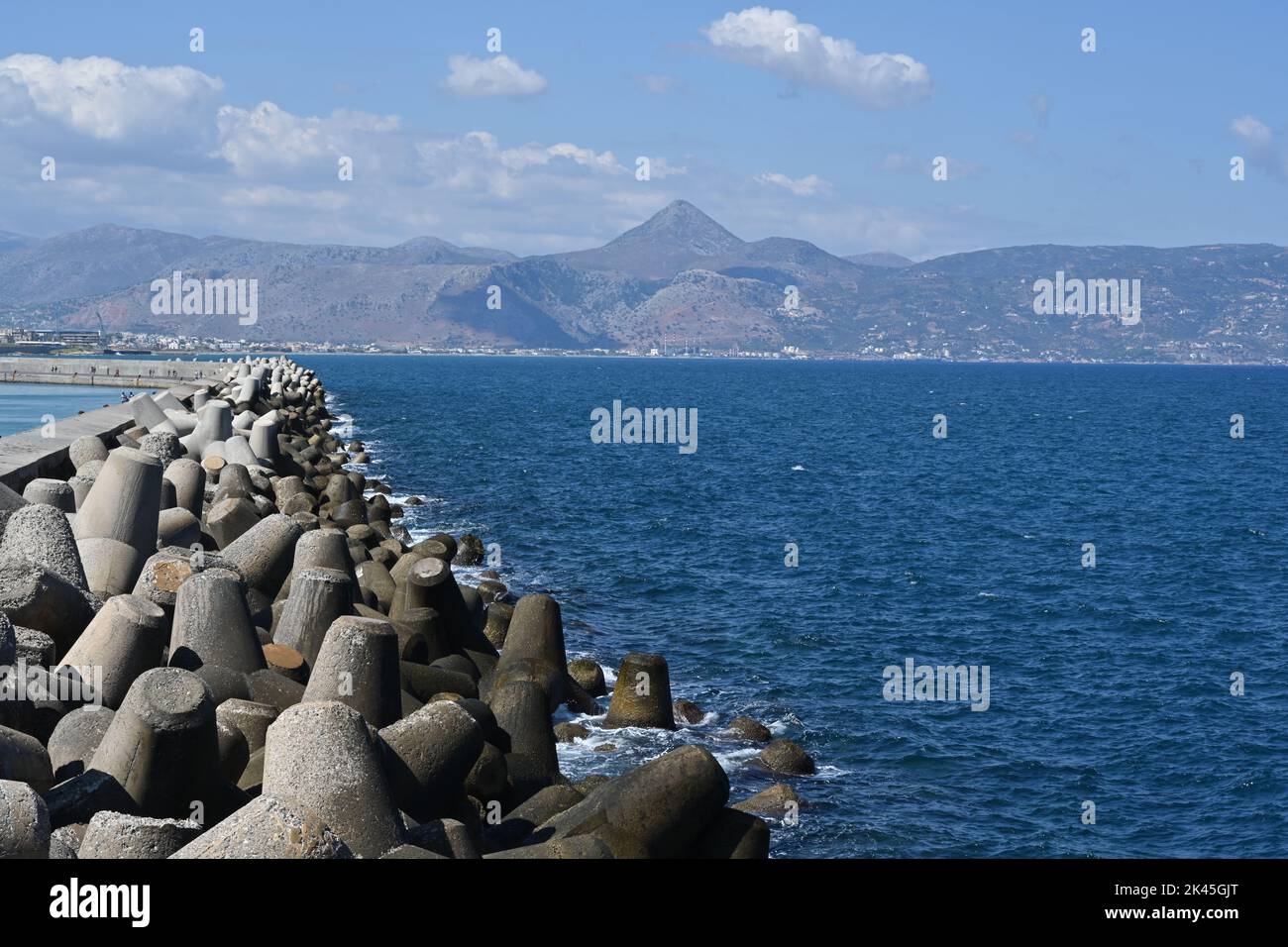 Concrete tetrapod breakwater stones piled up in wave breaker to protect Port of Heraklion, Stock Photo