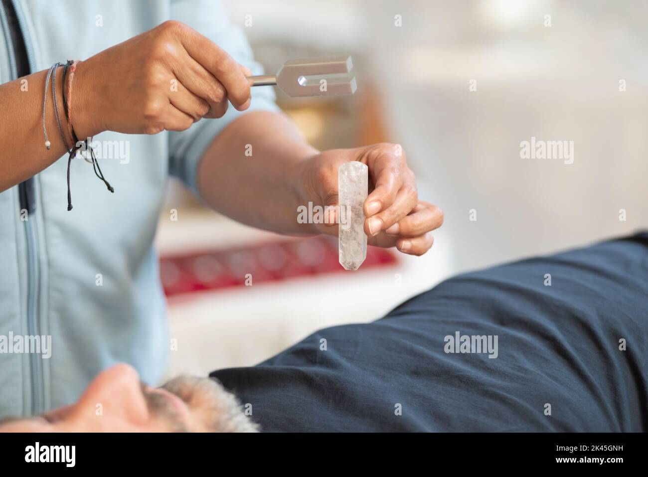 Music Therapist with Tuning Fork an Crystal Quartz Stock Photo