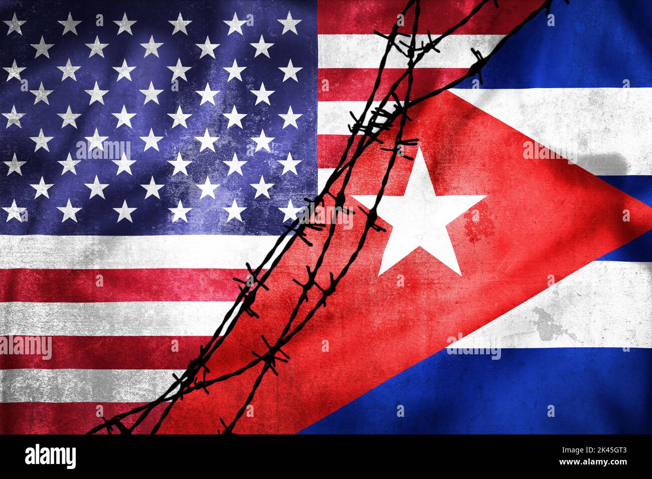Grunge flags of USA and Cuba divided by barb wire illustration, concept of tense relations between USA and Cuba Stock Photo