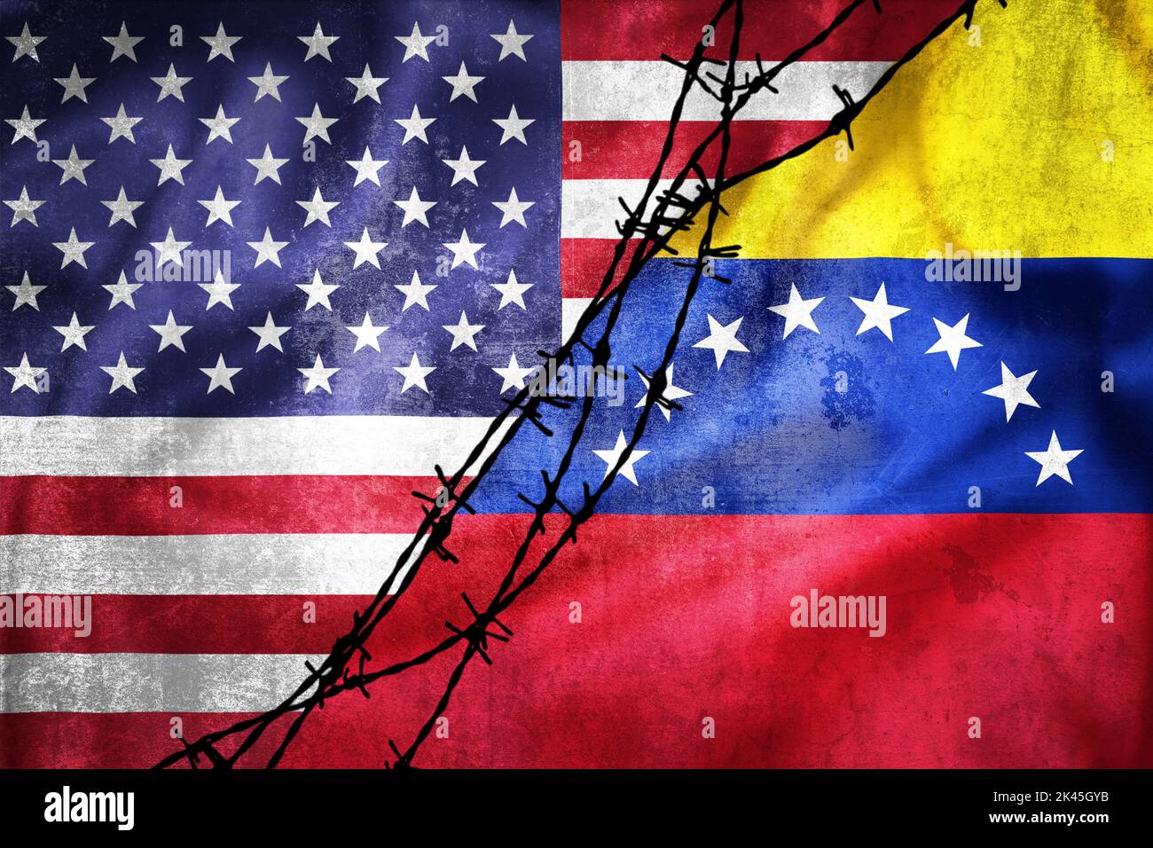 Grunge flags of USA and Venezuela divided by barb wire illustration, concept of tense relations between USA and Venezuela Stock Photo