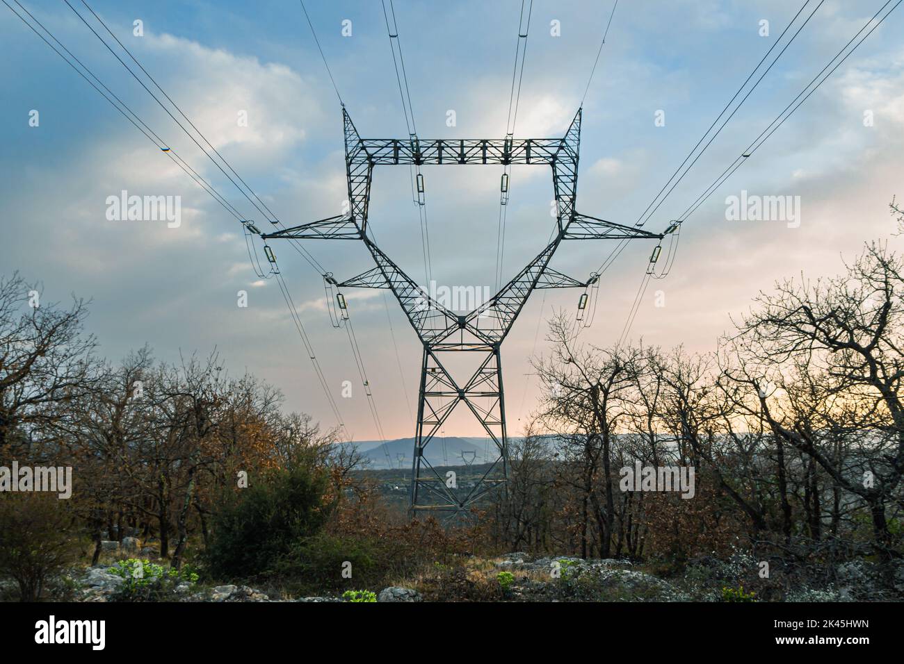high voltage electric line stretching between the mountain peaks during