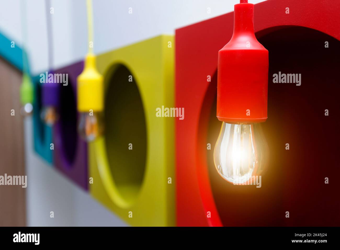 detail of several light bulbs lit in yellow color and warm tone, light fixture - concept of light Stock Photo
