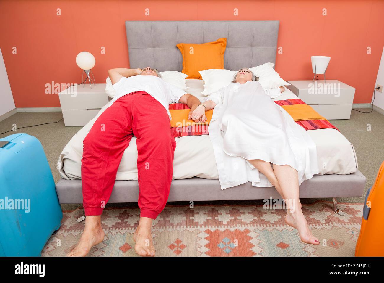 couple of mature people relaxing in the bedroom after a trip Stock Photo