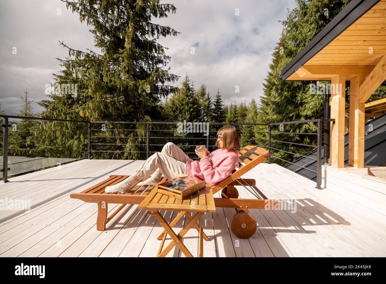 Woman rests on terrace in mountains Stock Photo - Alamy