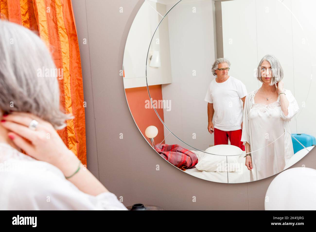 mature couple is mirrored before going to sleep Stock Photo