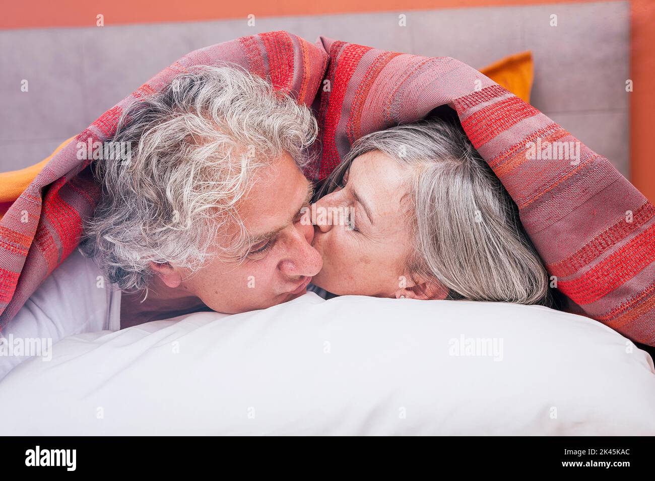 adult couple kissing in bed before sleeping Stock Photo