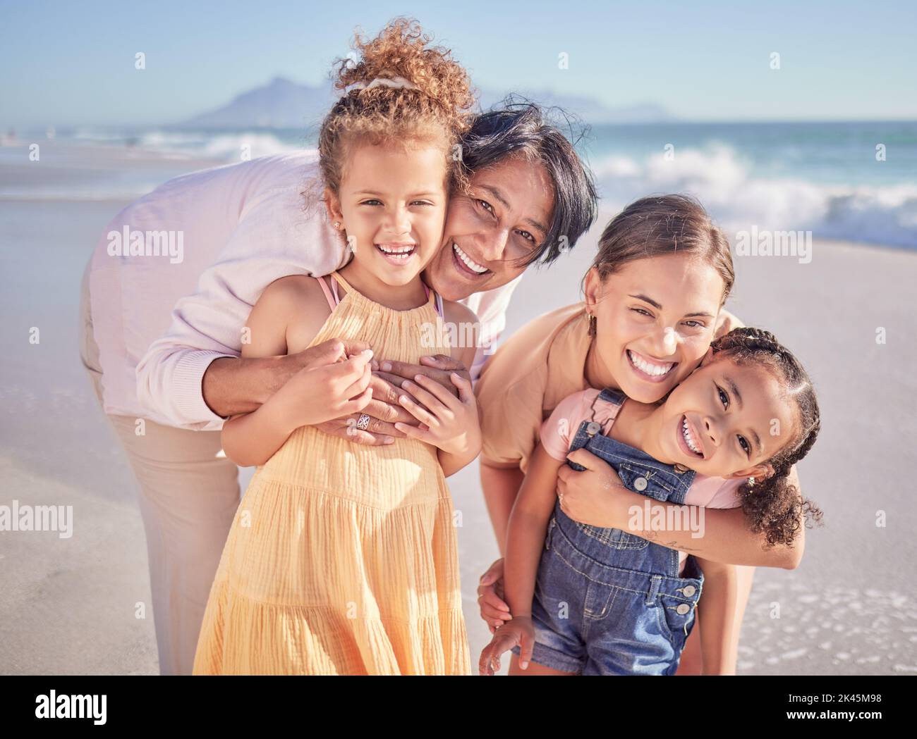Family, beach vacation and happy children with their mother and grandma out for fun, happiness and bonding on an adventure on a summer trip. Portrait Stock Photo