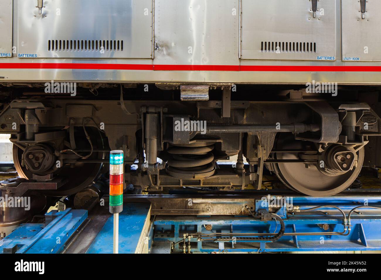 A train, the wheels and low section of a train carriage on rails. Stock Photo