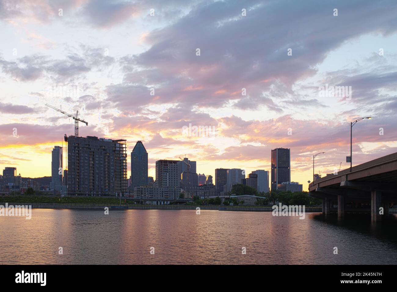 The Quebec city skyline and construction, downtown view from across the St Lawrence River at dawn. Stock Photo