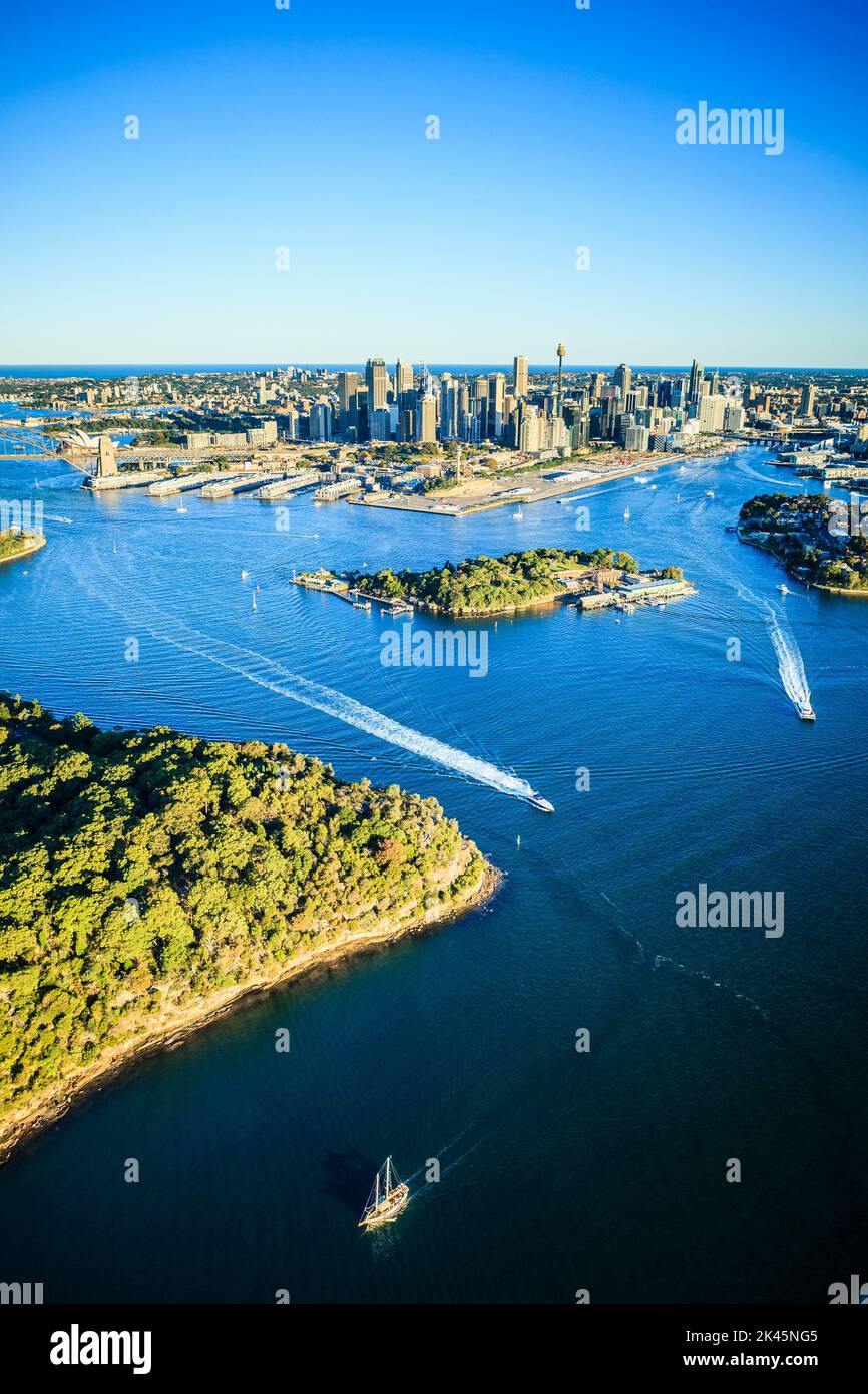 Aerial view over the city of Sydney, the water channels and the coastline of islands and boat traffic. Stock Photo