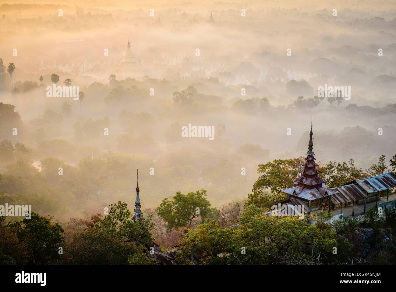 The view over the plain of temples, stupas rising from the mist, lakes and woodland. Stock Photo