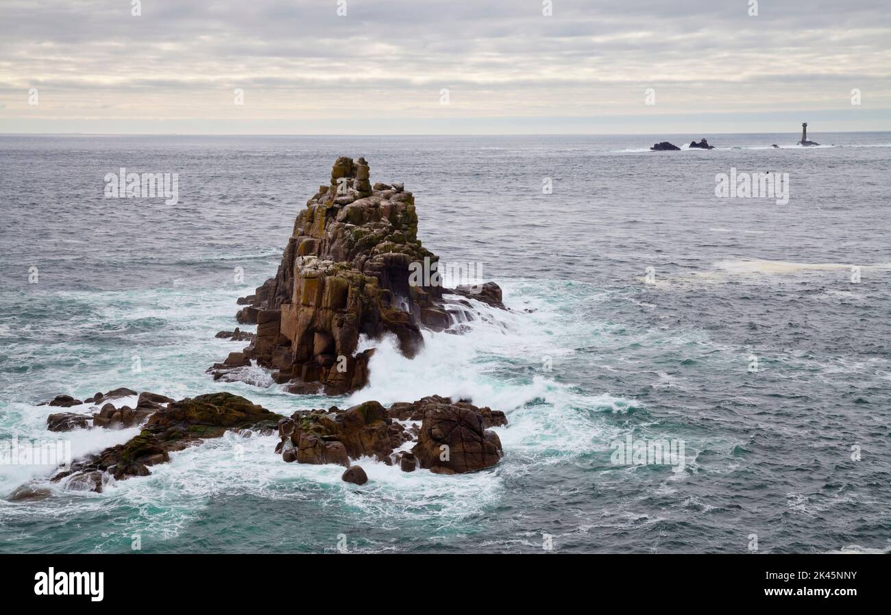 Land's End, rock islets offshore, the Penwith peninsula, view to a lighthouse and out to sea. Stock Photo