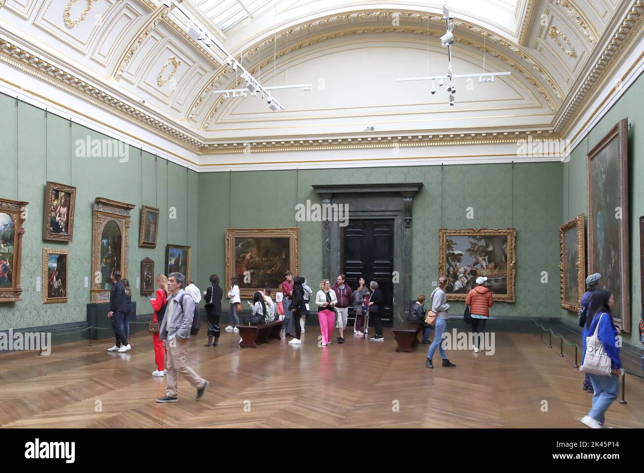 Visitors study Italian Renaissance paintings at the National Gallery, London, UK Stock Photo