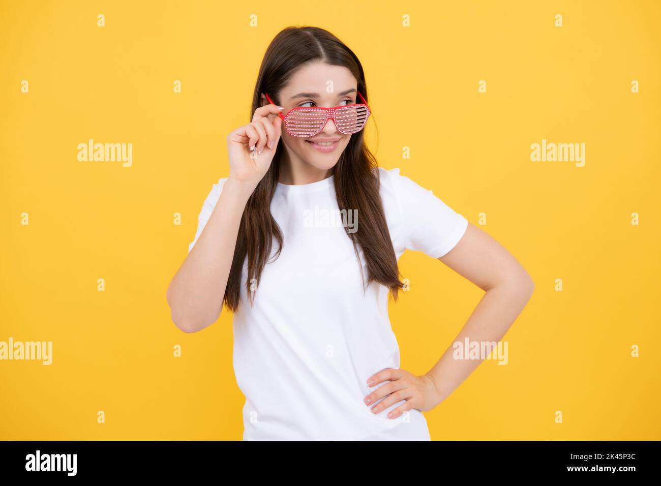 Surprised woman, shocking girl wearing funny glasses on isolated yellow background, Wow face feelings with copy space for advertising. Stock Photo