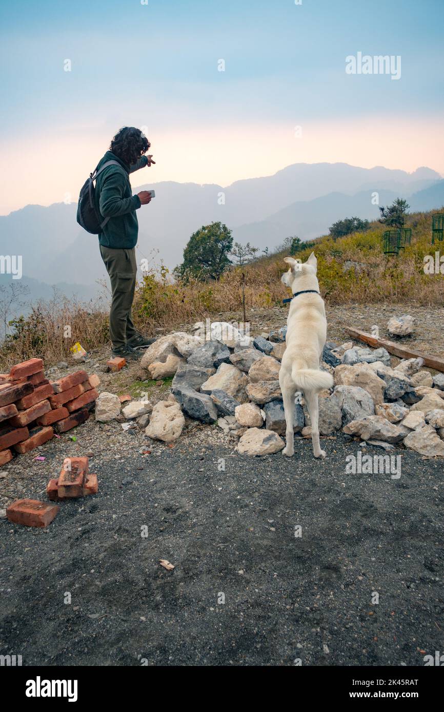 January 21st 2022 Dehradun City Uttarakhand , India. A man on a solo trip with his dog in the hills of Himalayas. Stock Photo