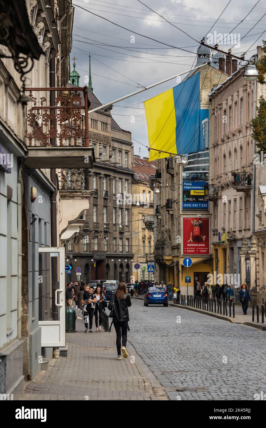 Ukraine Flag and Street Scene in Historic Lviv during War Time Stock Photo