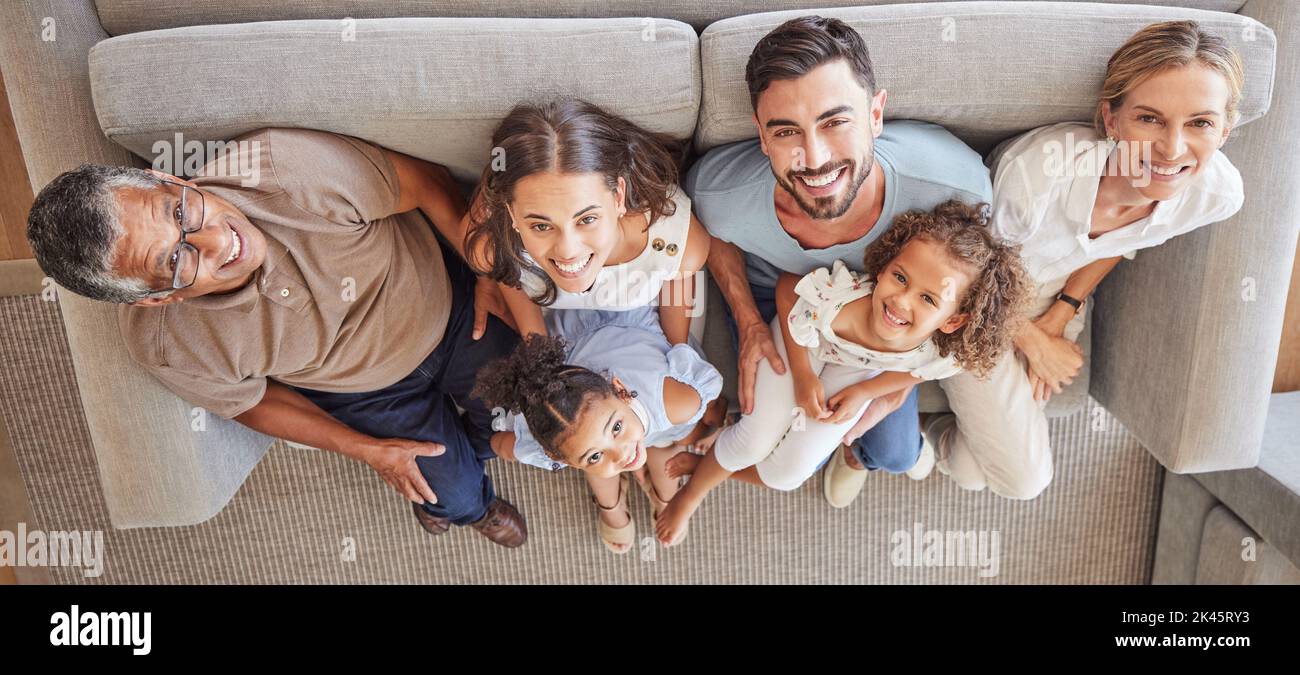 Happy big family, smile on sofa and top view of generations, grandparents and parents spend time together in living room. Love, diversity and couple Stock Photo