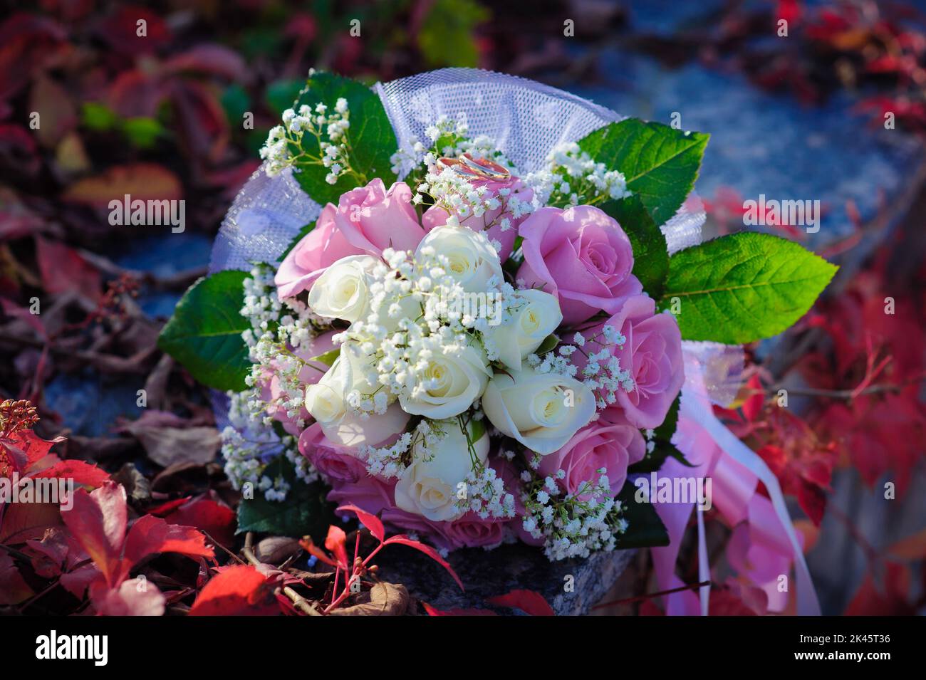Bridal wedding bouquet of flowers with golden rings. Wedding bouquet of ...
