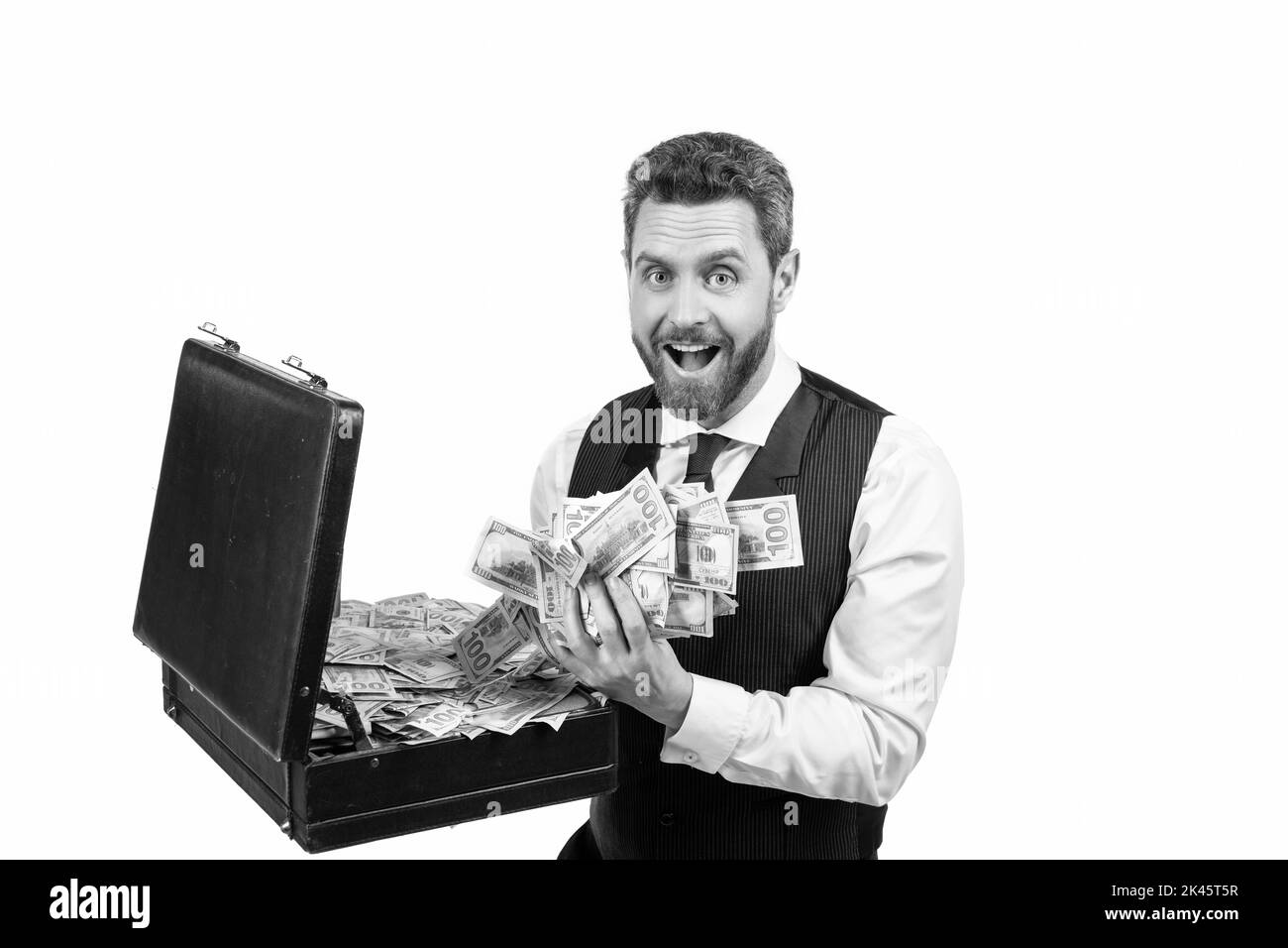 surprised millionaire holding case full of dollar cash isolated on white background, investment Stock Photo