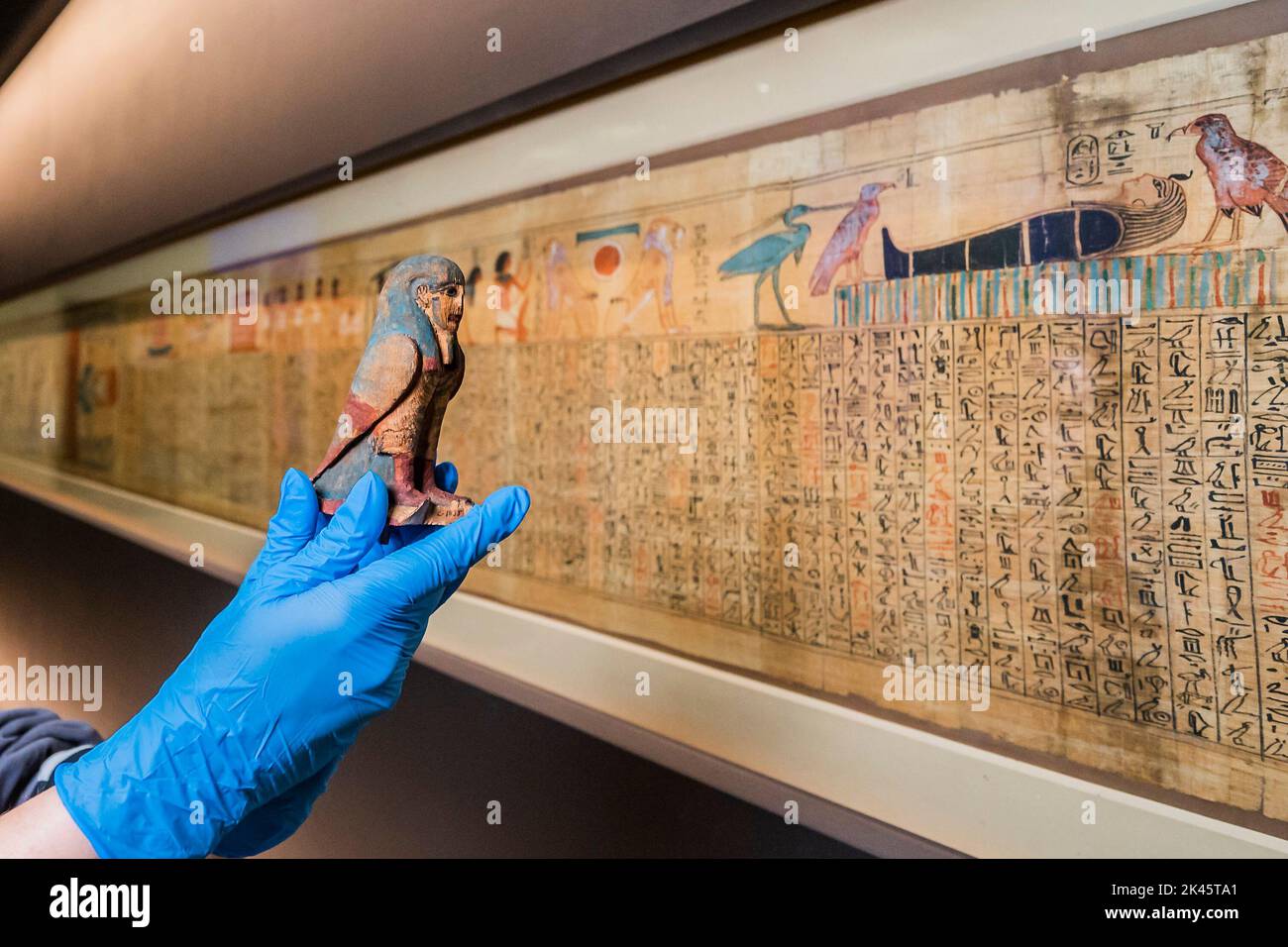London, UK. 26th Sep, 2022. An ancient Egyptian amulet is prepared for display in front of the 3,000 year old papyrus, the Book of the Dead of Queen Nedjmet - the British Museum prepares for the major exhibition Hieroglyphs: unlocking ancient Egypt which opens 13 October 2022. Credit: Guy Bell/Alamy Live News Stock Photo