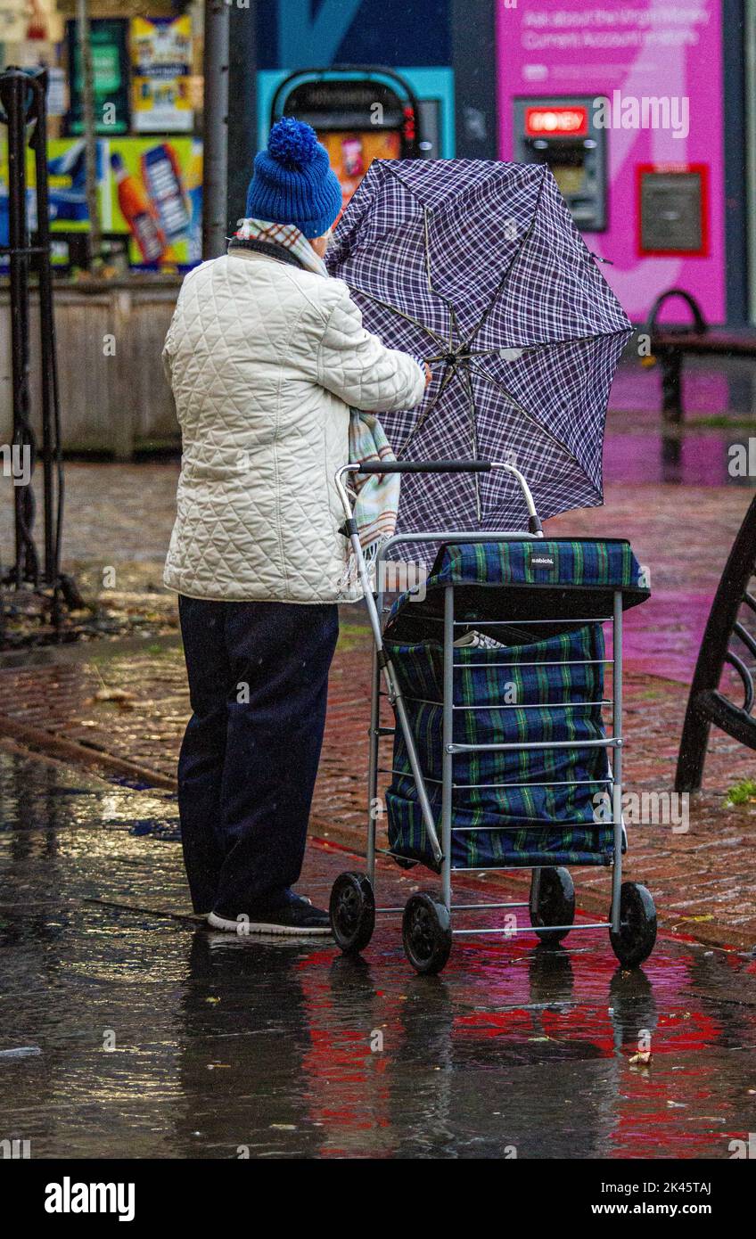 Dundee, Tayside, Scotland, UK. 30th Sep, 2022. UK Weather. A mix of unexpected heavy rain and strong wind gusts across the northeast of Scotland, with temperatures reaching 14°C. Despite the wet and windy Autumn morning, local women sheltering under brollies are out and about shopping in Dundee city centre, although somewhat cautiously due to the extremely high cost of living. Credit: Dundee Photographics/Alamy Live News Stock Photo