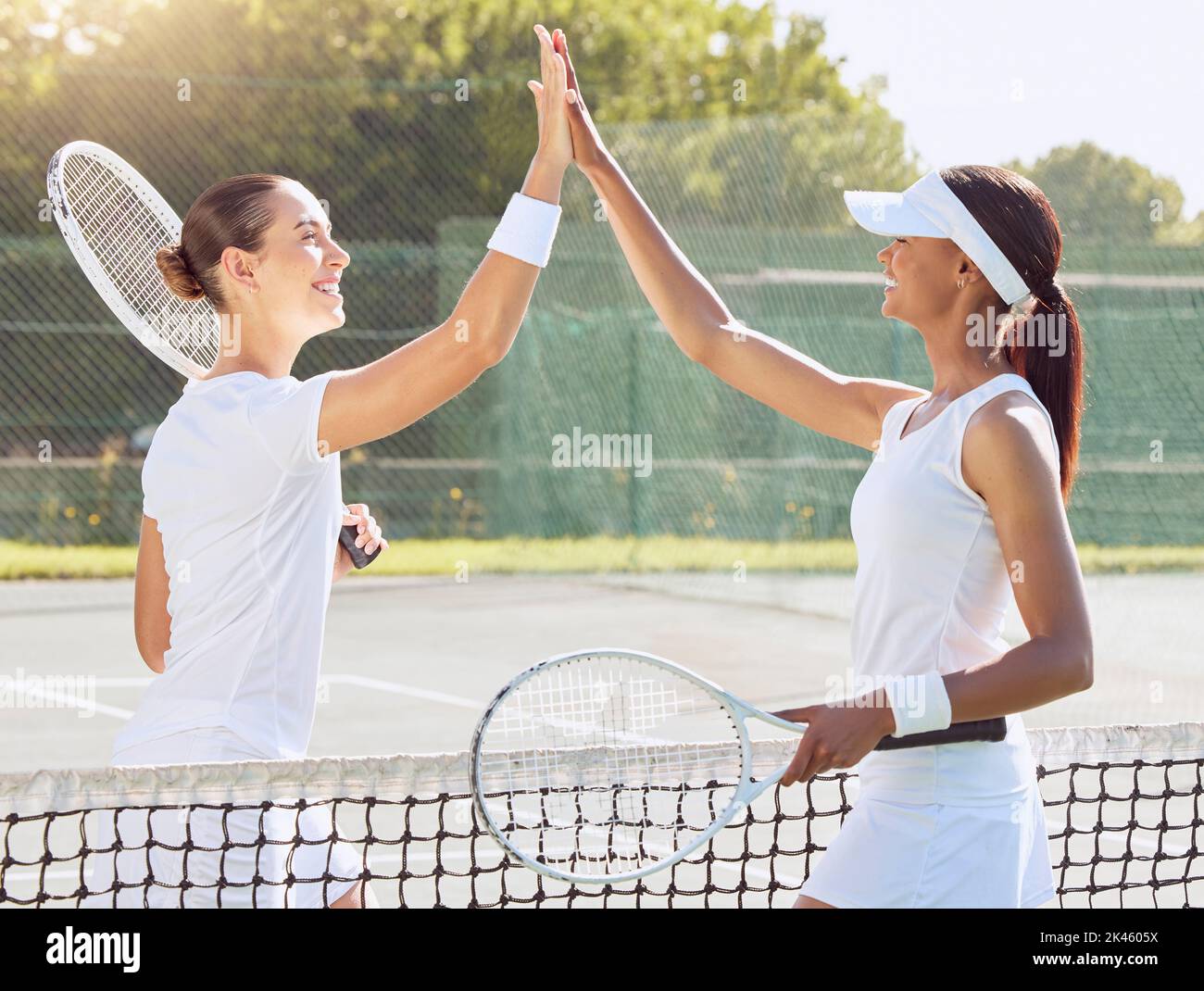 Tennis, woman and high five for sport, fitness match training or exercise workout at the court in the outdoors. Happy women friends in sports Stock Photo