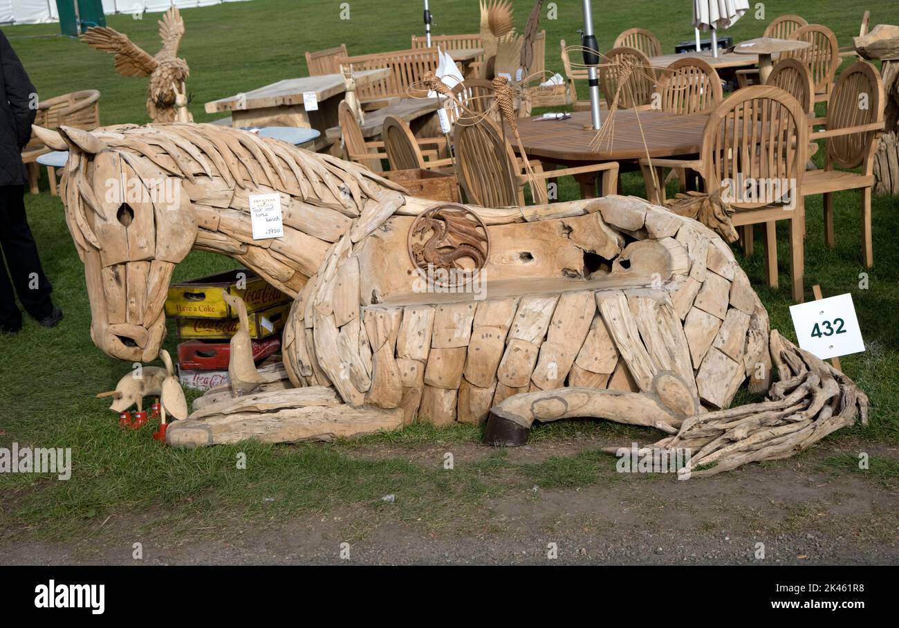 Sitting wooden horsesculpture  cleverly crafted fromf pieces of old driftwood wood for sale at Autumn Show Three Counties Showground, Great Malvern, U Stock Photo
