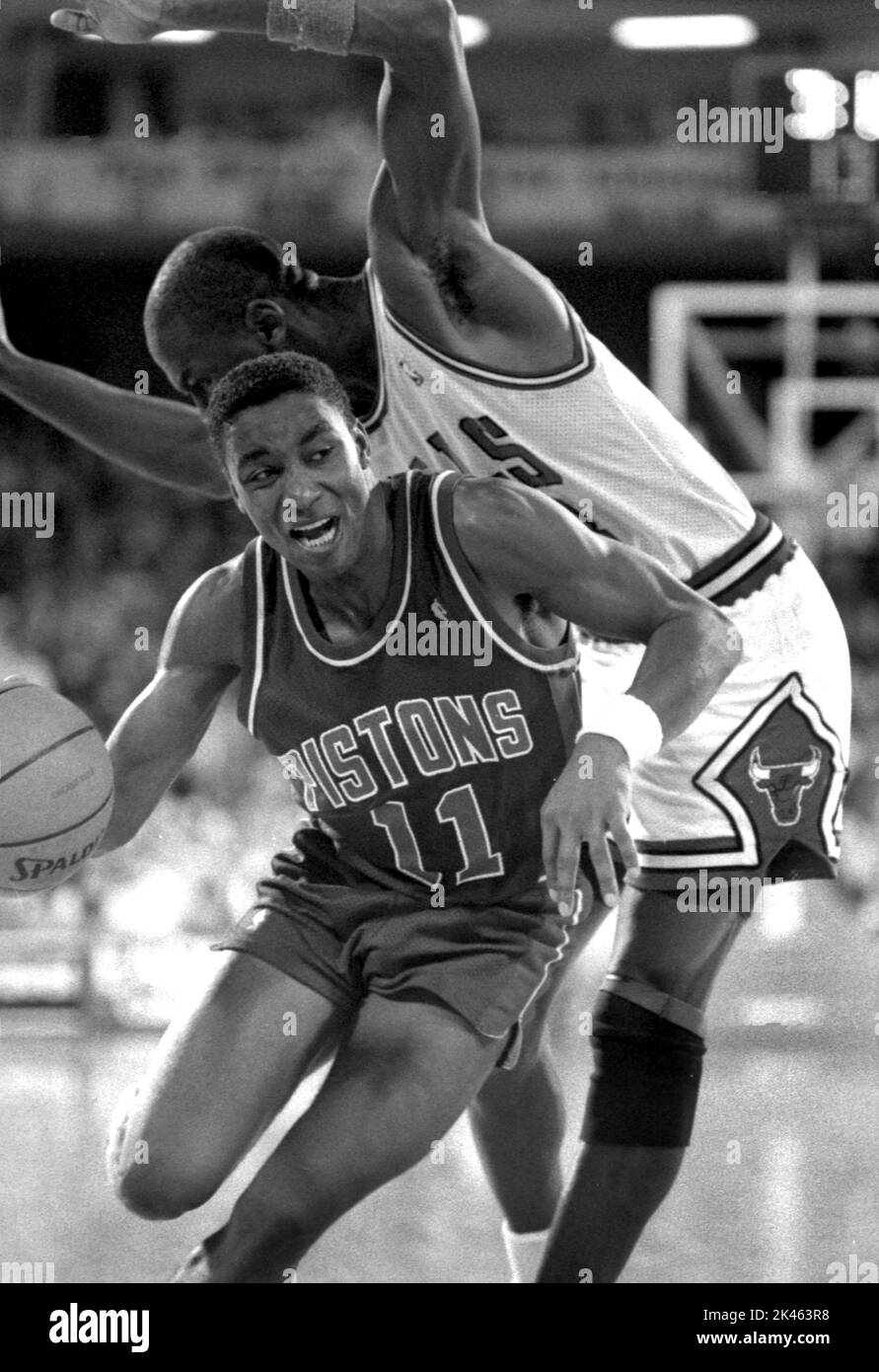 Detroit Piston Isiah Thomas drives past defender Michael Jordan of the Chicago Bulls in game action in the 1980s. Stock Photo