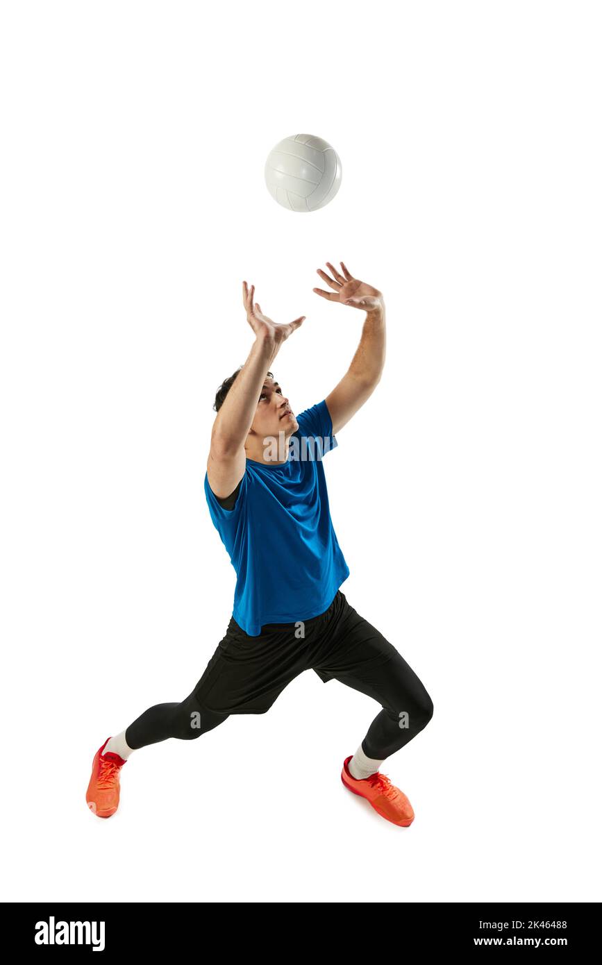 Dynamic portrait of male volleyball player training with ball isolated