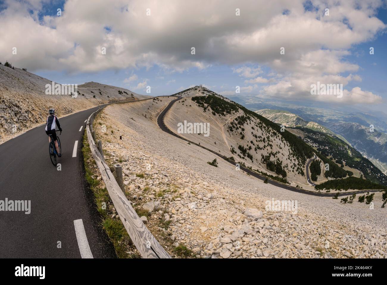 Female road cyclist descending Mont Ventoux, Provence, France. Stock Photo