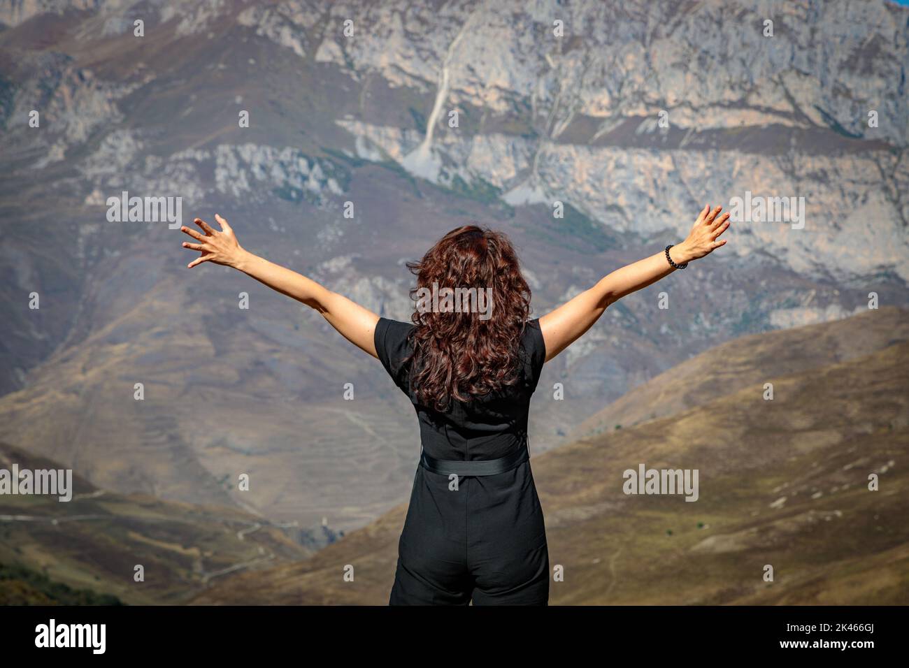 Woman on top of the hill with outstretched arms hi-res stock ...