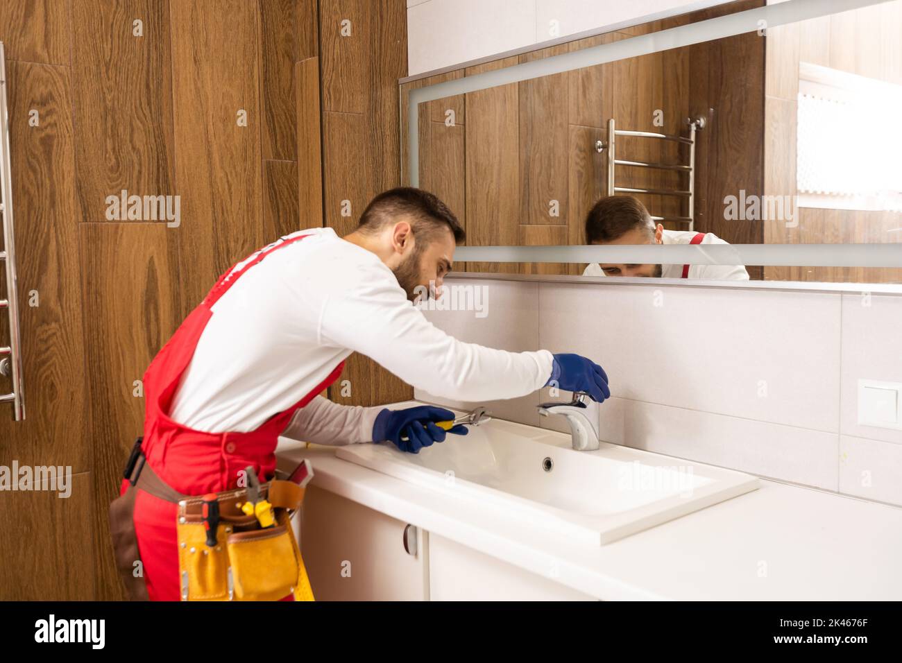 Kitchen sink trap. Drainage installation in a home kitchen. Dark