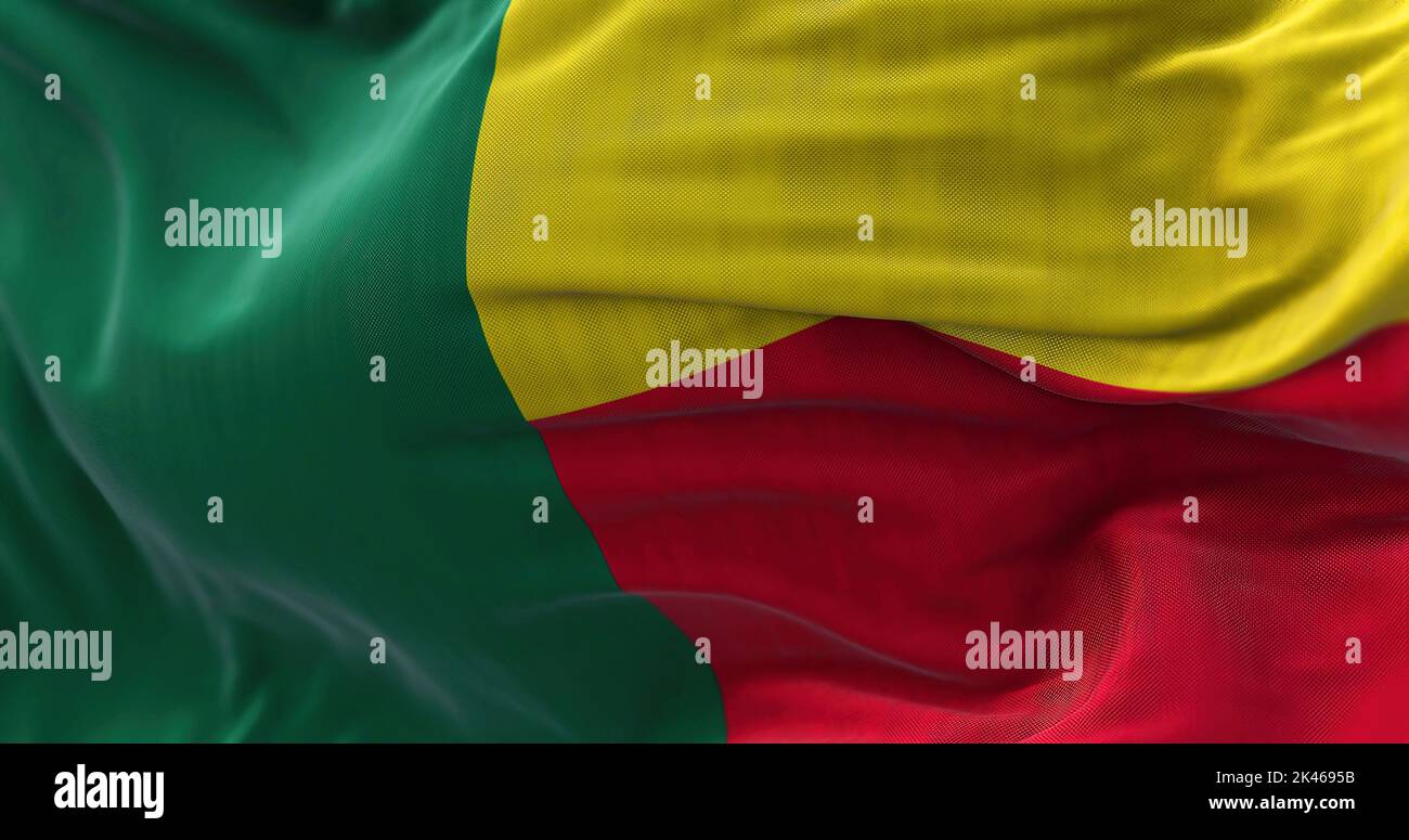 Close-up view of the Benin national flag waving in the wind. The Republic of Benin is a country in West Africa. Fabric textured background. Selective Stock Photo