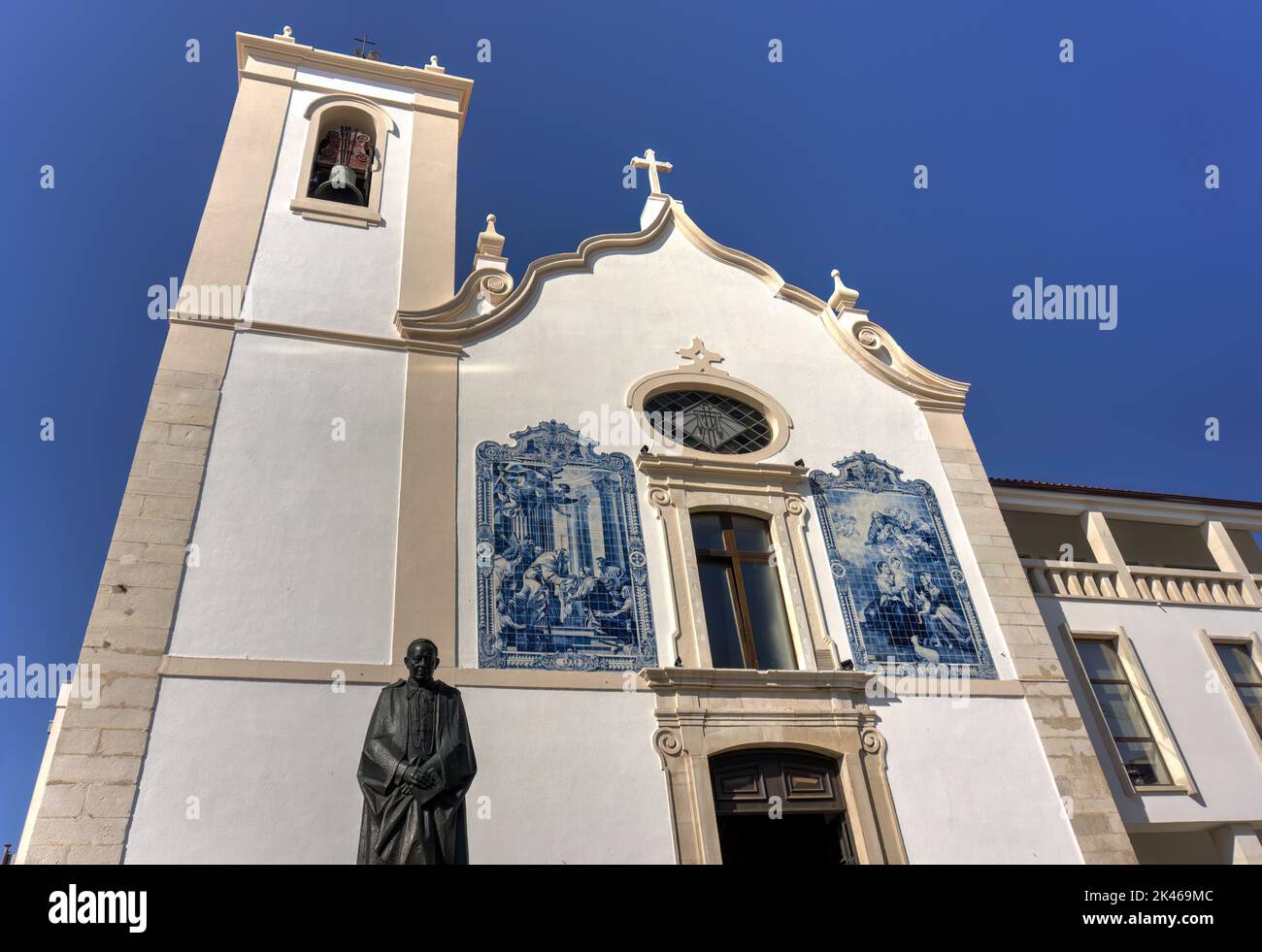 Aveiro, Portugal - August 14, 2022: Exterior of top of Vera Cruz church showing bell tower and ceramic tiles on wall Stock Photo